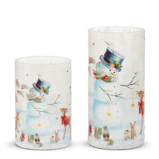 Two cylindrical candles with festive animal designs on a white background