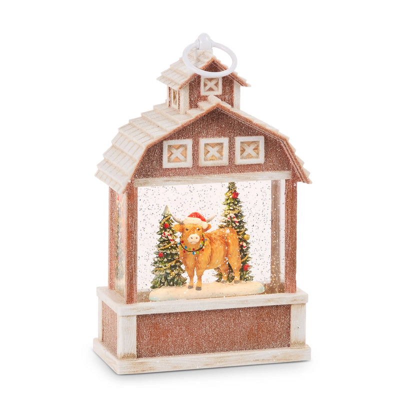 Decorative lantern with a cow and Christmas trees inside, on a white background