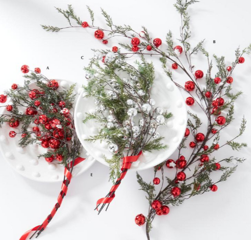Decorative branches with red berries and green leaves on a white background