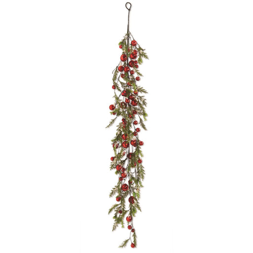A garland of green pine branches with red jingle bells and brown holly leaves, designed for Christmas decoration.