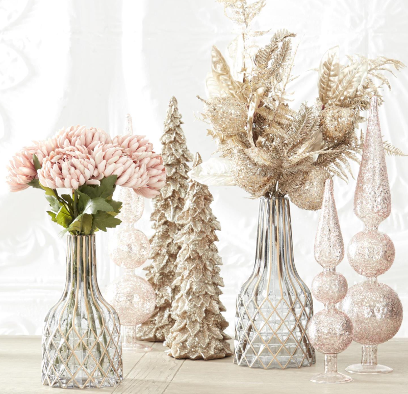 Decorative items including vases with flowers and decorative trees on a light background