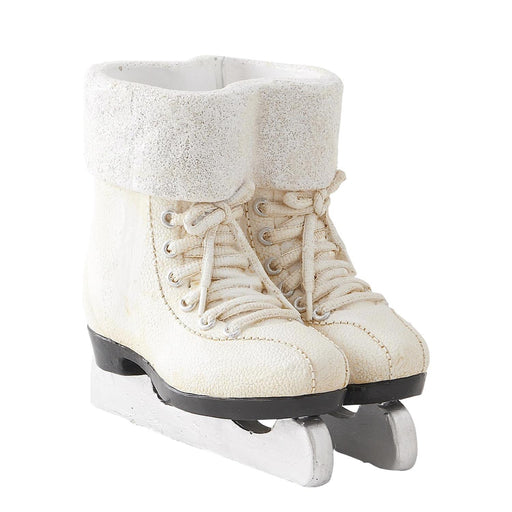 Pair of white ice skates with textured top on a white background