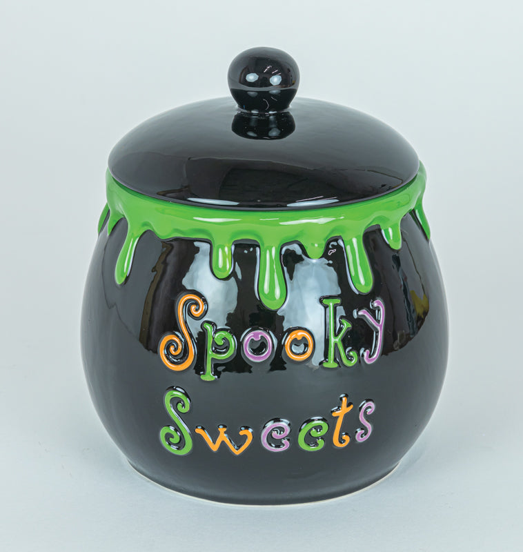 Black jar with green lid and colorful text 'Spooky Sweets' on a light gray background