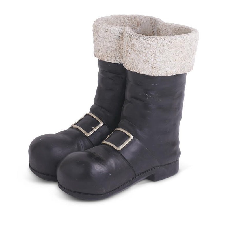 Pair of black boots with white fur lining on a white background
