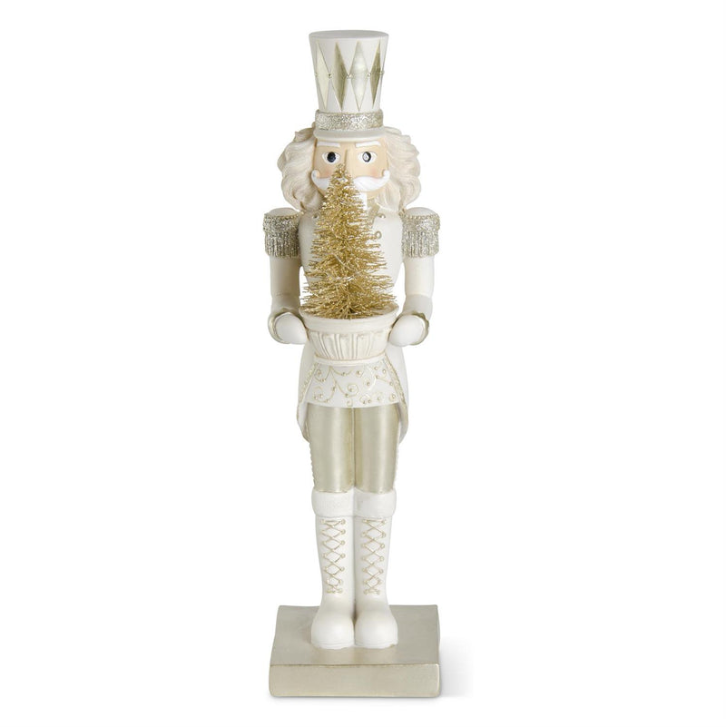 Decorative nutcracker figure holding a gold tree on a white background