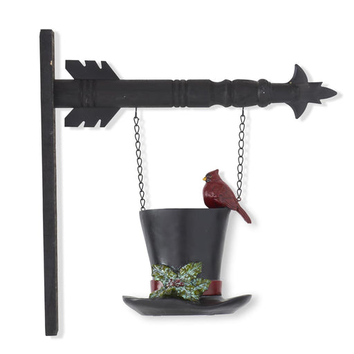 Decorative bird feeder shaped like a black top hat with a cardinal on a white background