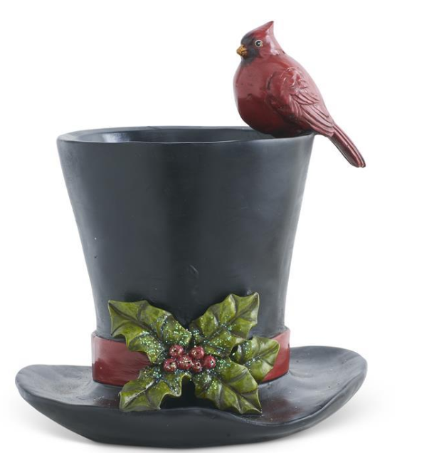 Decorative planter with a red cardinal bird and holly leaves on a white background