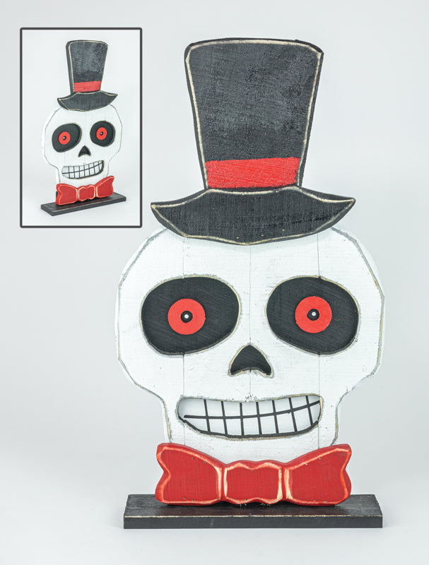 A decorative skull figurine with a black top hat, red bow tie, and red-and-black eyes, shown on a light gray background with a small inset image showing the full product from a different angle.