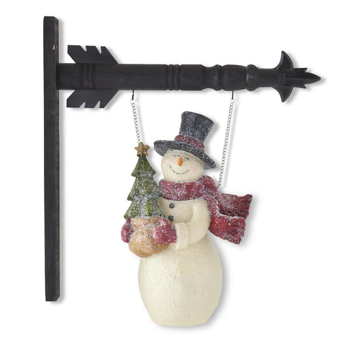 Decorative snowman ornament with a black arrow on a white background