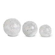 Three clear LED snowflake tabletop glass globes of varying sizes, with a white background.