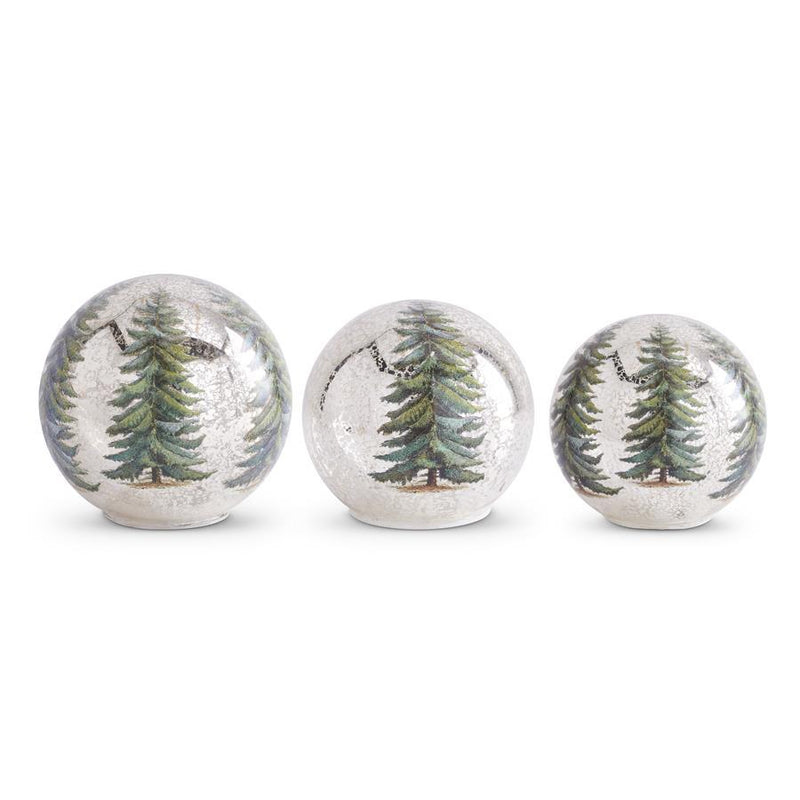 Three decorative balls with tree patterns on a white background