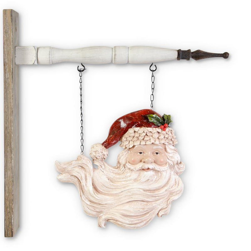 Decorative wall hanging of a Santa Claus face with a long beard, wearing a red hat, on a white background.
