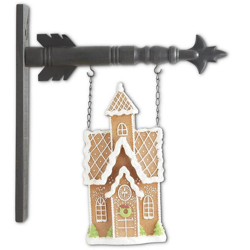 Decorative gingerbread house ornament on a white background