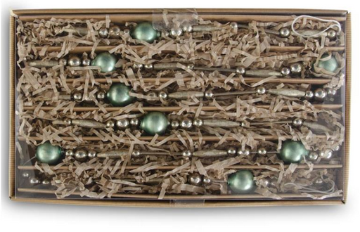 Box of decorative green and silver beads on a white background