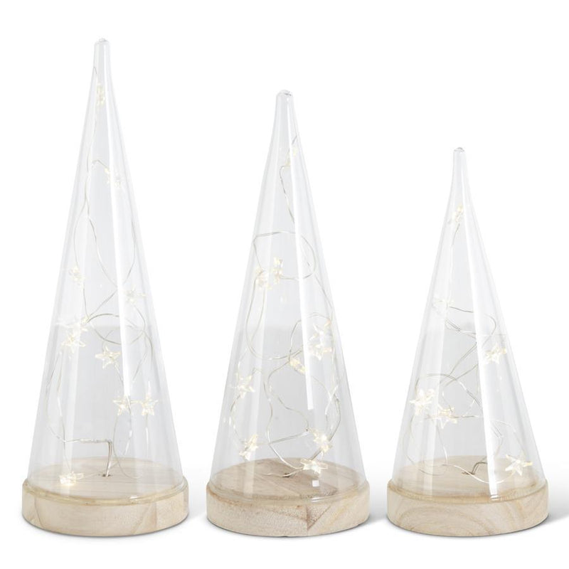 Three conical glass trees with LED star garland lights, each on a wooden base, intended as tabletop Christmas decor.
