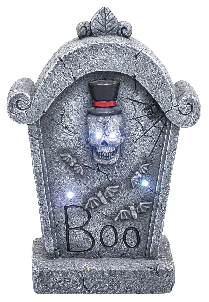A Halloween tombstone decoration with a gray faux-stone texture, a skull wearing a black top hat with a red band, glowing blue eyes, bats, spiderwebs, and the word 'Boo' on the front, shown on a white background.
