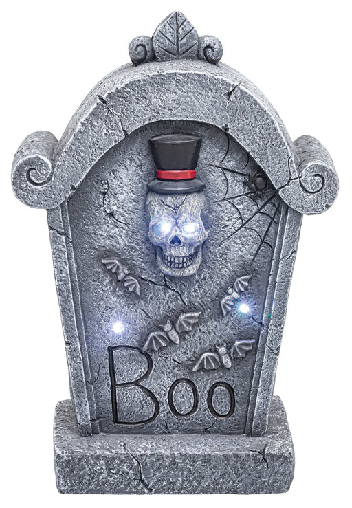 A Halloween tombstone decoration with a gray faux-stone texture, a skull wearing a black top hat with a red band, glowing blue eyes, bats, spiderwebs, and the word 'Boo' on the front, shown on a white background.