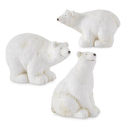 Three white polar bear figurines on a white background