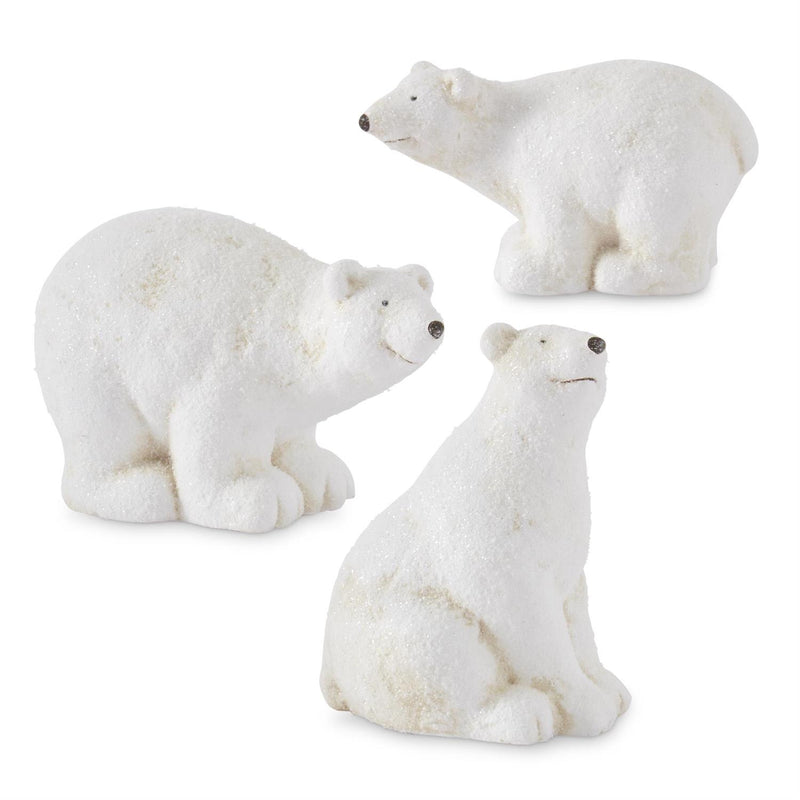 Three white polar bear figurines on a white background