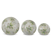 Three decorative glass spheres with floral patterns on a white background