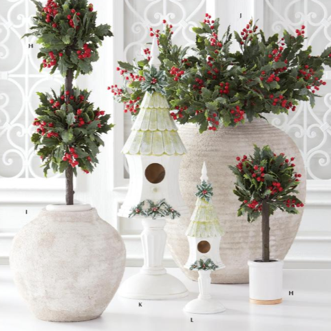 Decorative Christmas scene with topiaries, birdhouse, and trees in vases.