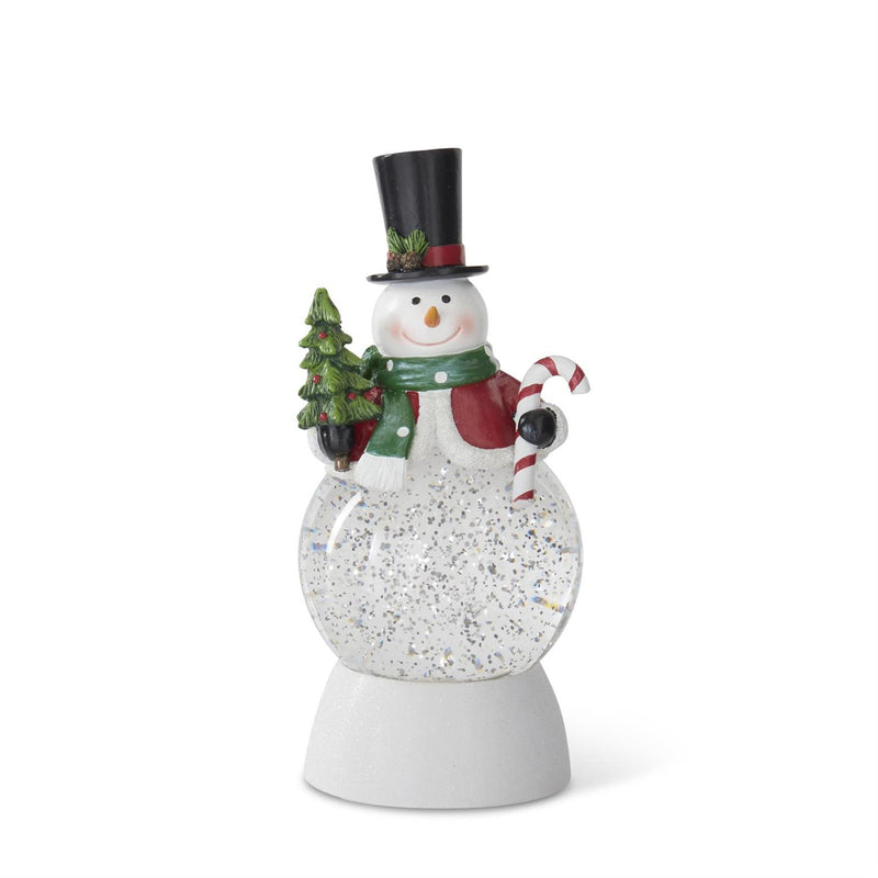 Decorative snowman with a top hat, scarf, and candy cane inside a snow globe on a white background