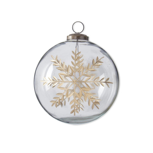 Clear glass ornament with gold snowflake design on a white background