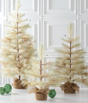 Three decorative trees with burlap bases and green ornaments on a white surface.