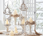 Decorative candle holders with beaded accents on a white surface.