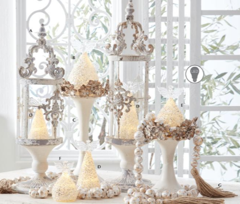 Decorative candle holders with beaded accents on a white surface.
