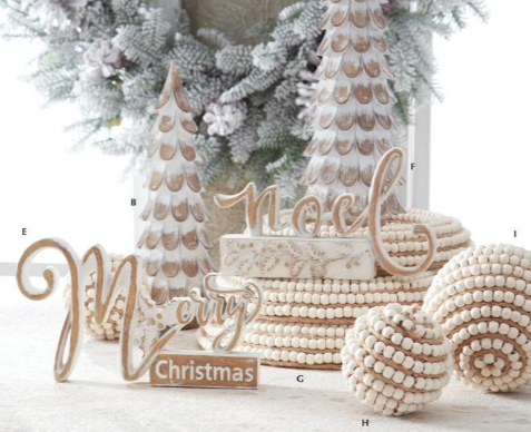 Decorative Christmas items including wooden trees, beads, and 'Merry Christmas' sign in a festive setting.