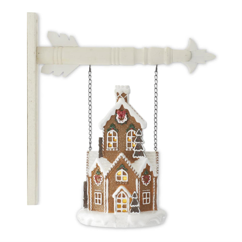 Decorative gingerbread house ornament on a white background