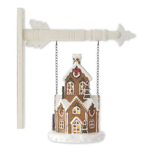 Decorative gingerbread house ornament on a white background