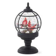 A spinning water LED snow globe with black grid design and red cardinals, on a black base.