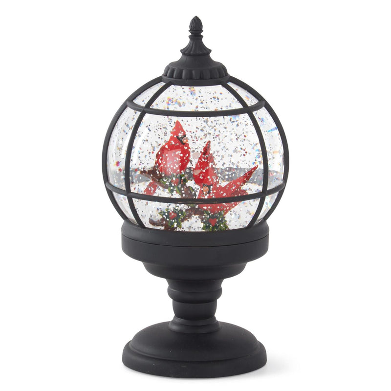 A spinning water LED snow globe with black grid design and red cardinals, on a black base.