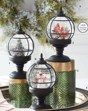 Decorative glass globes with water and Christmas trees on a white background