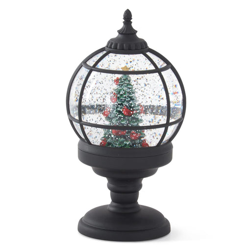 Decorative snow globe with a Christmas tree on a white background