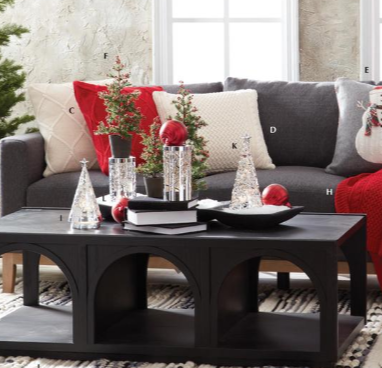 Living room with a gray sofa, coffee table, and decorative items.