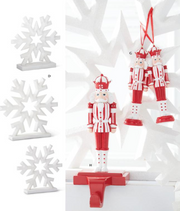 Red and white nutcracker ornaments on a decorative stand with snowflake decorations.