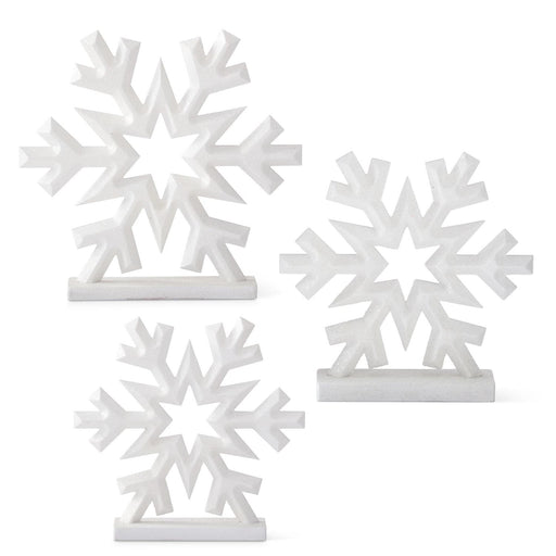 A set of three white glittered snowflake decorations on a base, in different sizes.