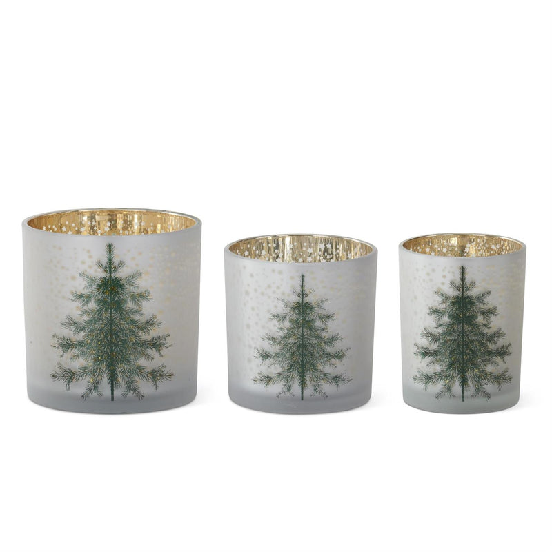 Three decorative candle holders with tree designs on a white background