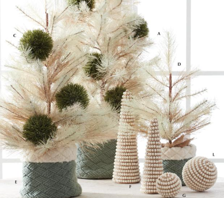 Decorative Christmas trees with natural elements and beaded ornaments on a white surface.