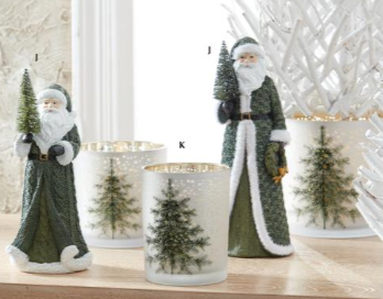 Decorative candles with Santa Claus figures and Christmas trees on a wooden surface.