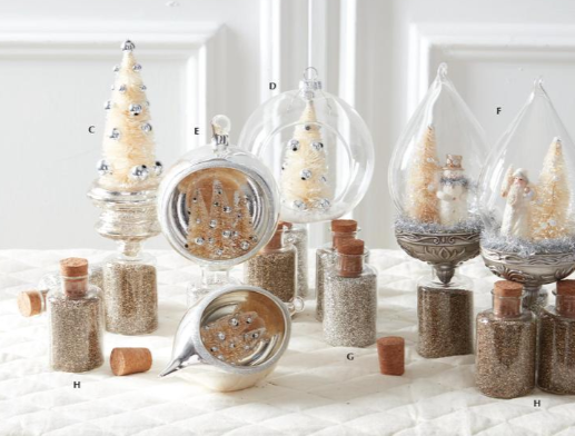 Decorative items including small trees, bottles, and jars on a white surface with a white background.