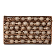 Box of decorative beads with a rustic brown box on a white background