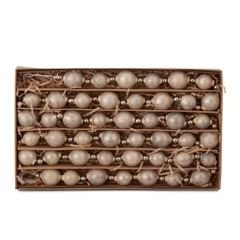 Box of decorative beads with a rustic brown box on a white background