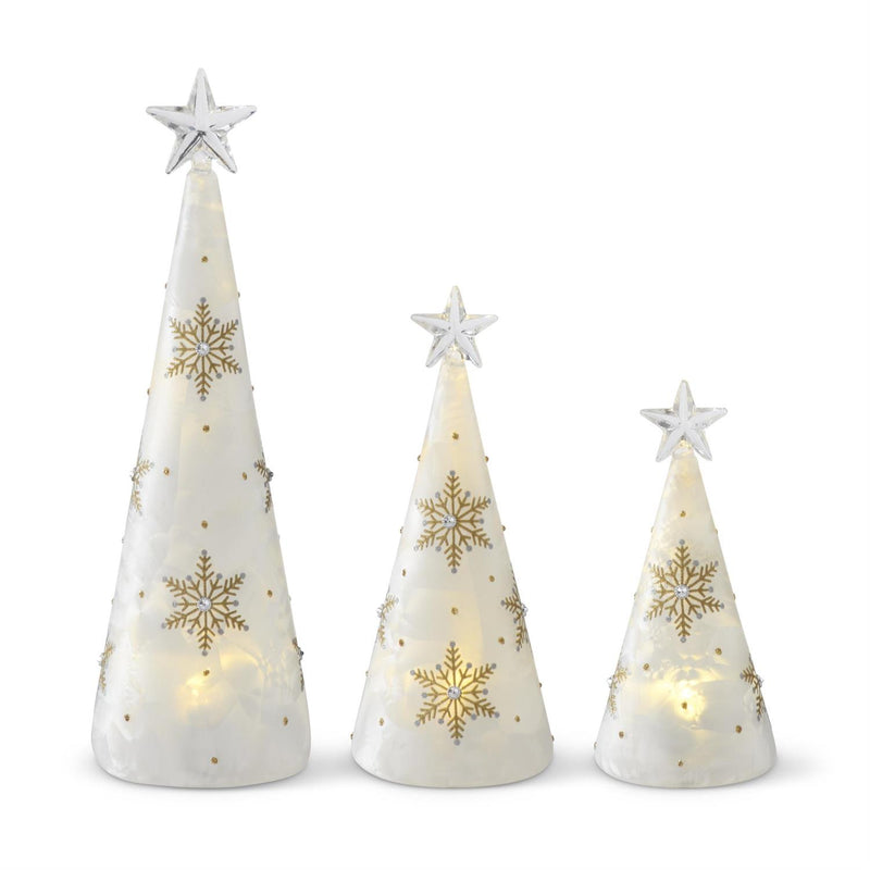 Set of three decorative Christmas trees with snowflake patterns and star toppers on a white background.