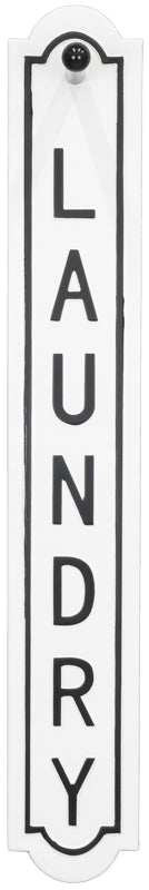 A vertical white sign with black border and the word 'LAUNDRY' printed vertically in large black letters.