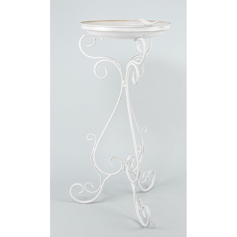 A white wrought iron garden table with an oval top and ornate scrollwork legs, shown against a light gray studio background.