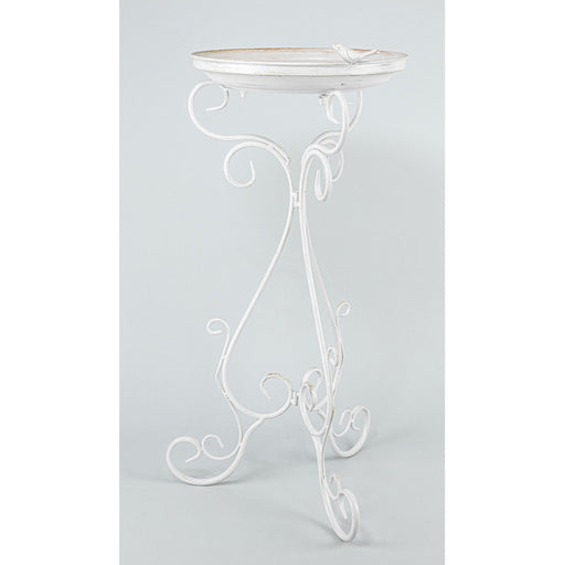 A white wrought iron garden table with an oval top and ornate scrollwork legs, shown against a light gray studio background.